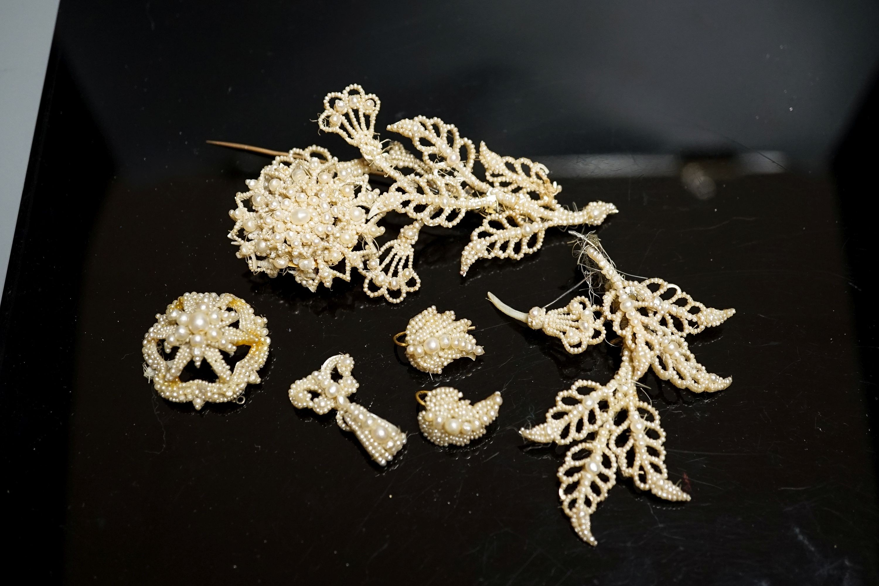 A 19th century seed pearl set flower brooch, 95mm and five other pieces of seed pearl jewellery.